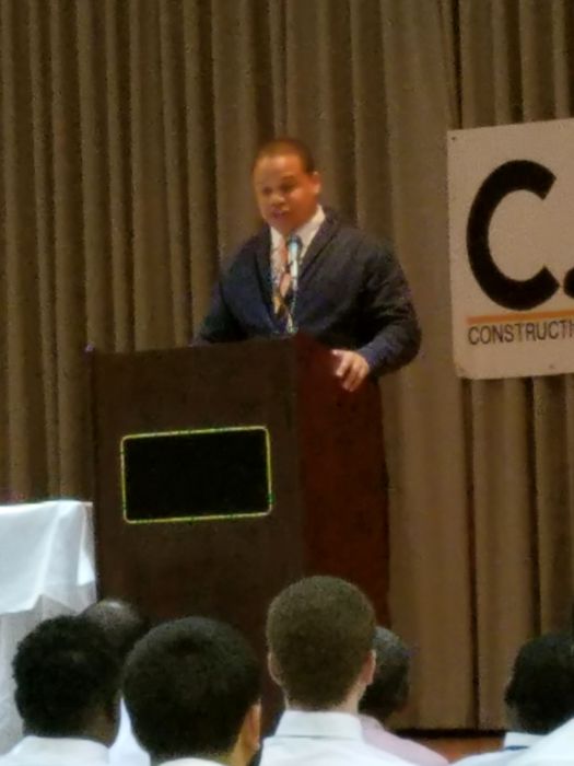 A speaker addresses the graduating class from the podium